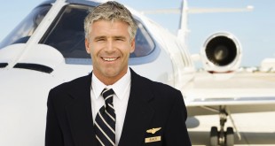 Pilot in Front of Private Jet --- Image by © Royalty-Free/Corbis